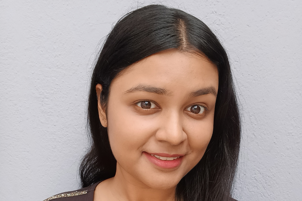 A professional woman with a radiant smile reflecting satisfaction from the best dry needling physiotherapy in JP Nagar.