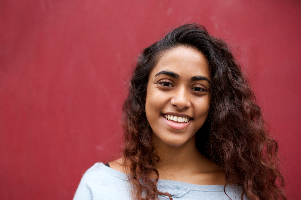 A radiant woman confidently presenting a positive outlook supported by the Best Antenatal and Postnatal Physiotherapy in JP Nagar.