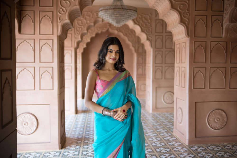 Woman in traditional Indian attire standing confidently in a historic corridor showcasing the Best Kinesio Taping Physiotherapy in JP Nagar.