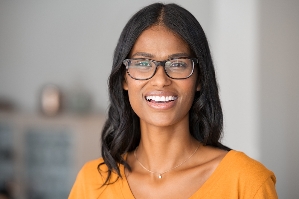 A joyful individual wearing glasses, symbolizing the success stories of the Best Antenatal and Postnatal Physiotherapy in JP Nagar.